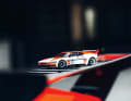 Auf dem Heckflügel des Originals aus der Sammlung Loh verschmilzt das 1:18-Modell des BMW beinahe mit Laudas BMW M1 im Procar-Trimm
