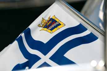 What's behind the flags with coats of arms