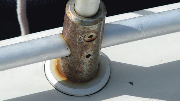 The classic surface and crevice corrosion at the base of a railing support.