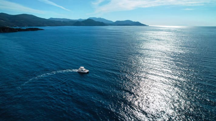 Our boat and the view to the south along the mainland coast of Epirus with Cape Varlaam