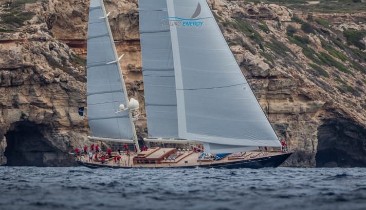   The Langan design "Huckleberry" (Alloy Yachts) against a mighty mountain backdrop