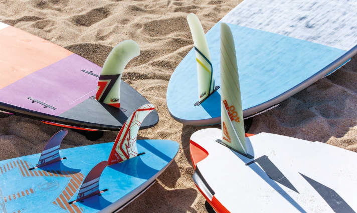The fin configuration and footstrap options reveal a great deal about the board’s intended use. As a general rule, the further out the footstraps are and the straighter the fins are, the more the board is designed for speed and performance.