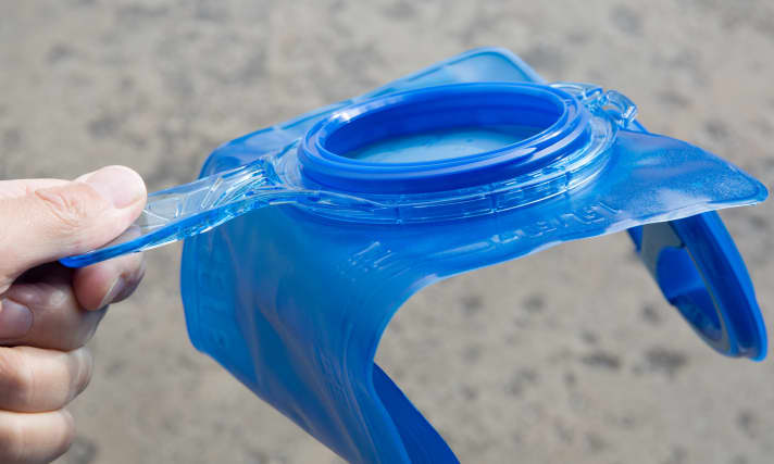 Hydration bladder with large opening and practical handle for filling.