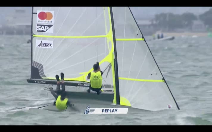   The screenshot from the live TV broadcast shows the unfortunate moment for Peter Burling when he lost his footing and went overboard for a few seconds