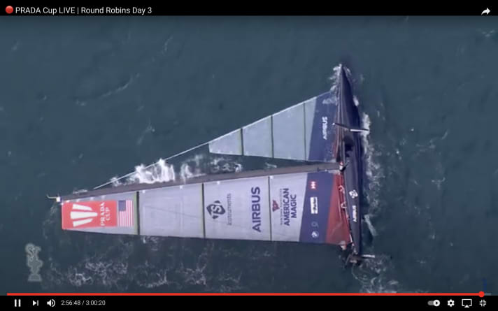   Finally capsized, "Patriot" lies flat on the water with the mainsail