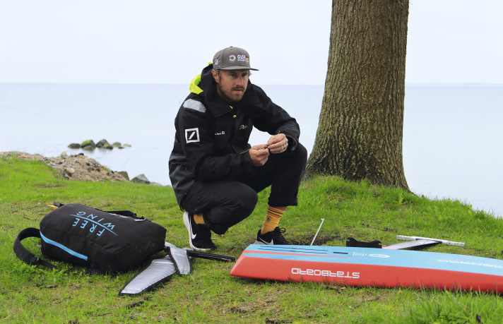SailGP skipper Erik Heil rigs his wingfoil material.