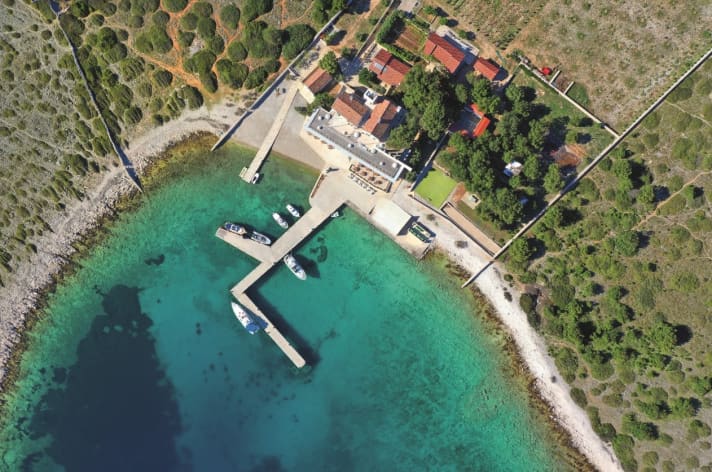 The island of Ravni Žakan floats like a green jewel in the south of the archipelago on the deep blue of the Adriatic Sea