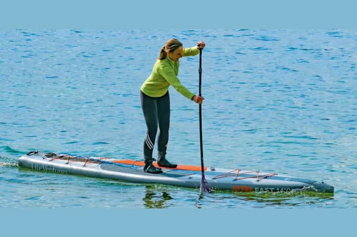 Stand in the middle, with a long, sleek board featuring a pointed, flat bow and a vertical paddle position: this way, you can paddle six or seven times on one side without veering off course.