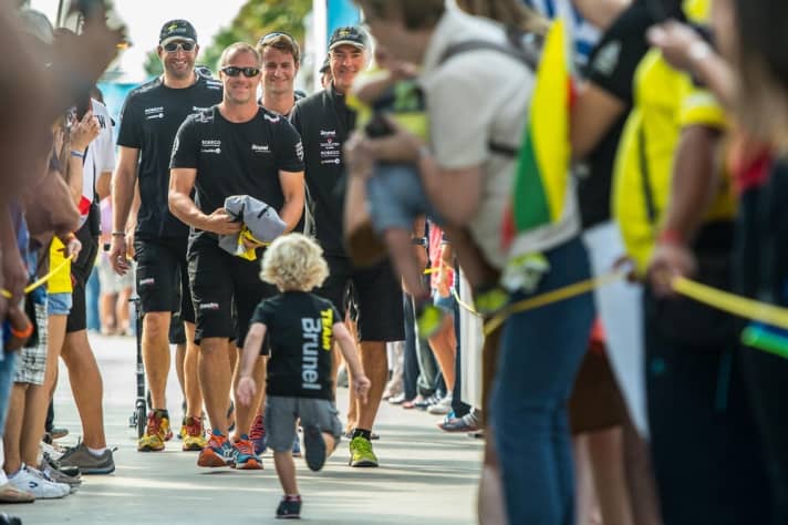   A little fan from Team Brunel delights the team and fans at the parade in Alicante