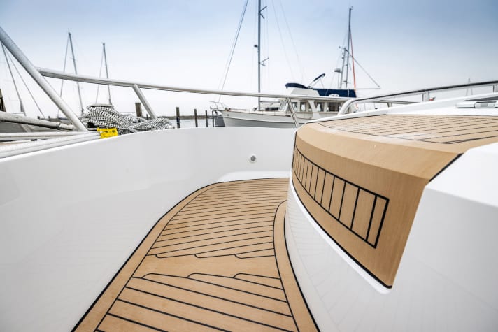 It looks similar to teak, but is synthetic