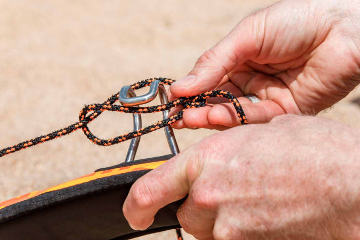 ...you can now push through a trimming aid, e.g. the trapeze hook or a screwdriver...