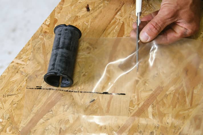Cut a piece out of the rubber that is slightly wider than the bottom cuff of the front piece.