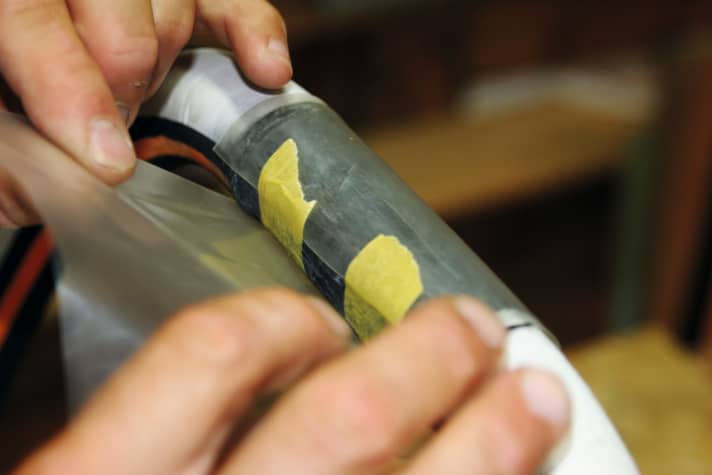 Pull it tight and secure the rubber with a strip of Tesa masking tape.