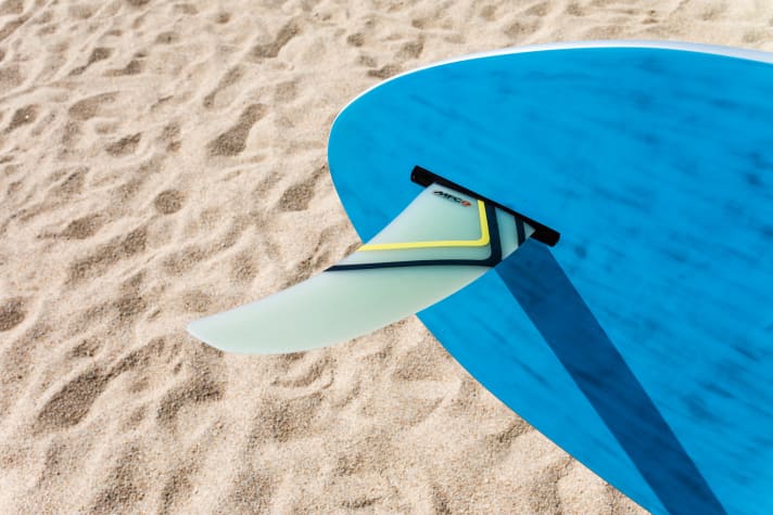 The fin sits in the tail on the lower side