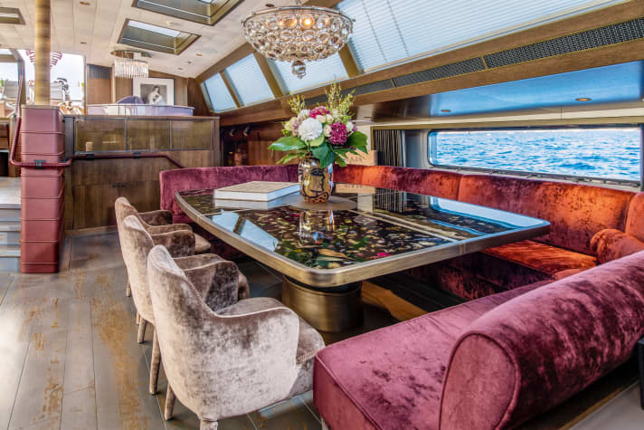 Deckhouse: The lower dining area is illuminated by a chandelier from the "Pink Gin V"