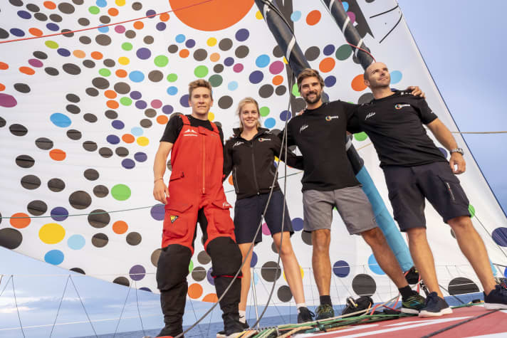 The crew of the "Malizia - Seaexplorer" in front of the new spinnaker (from right to left): Nicolas Lunven, Boris Herrmann, Rosalin Kuiper and Will Harris