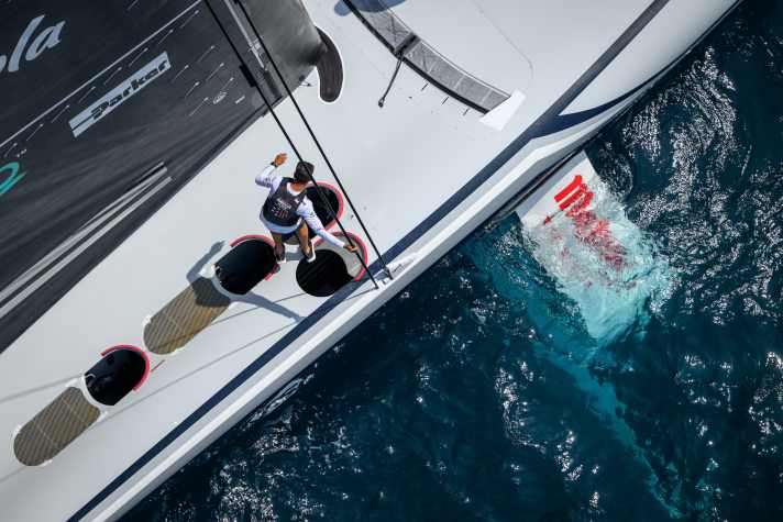 The cyclists lie in the two pods at the back of American Magic