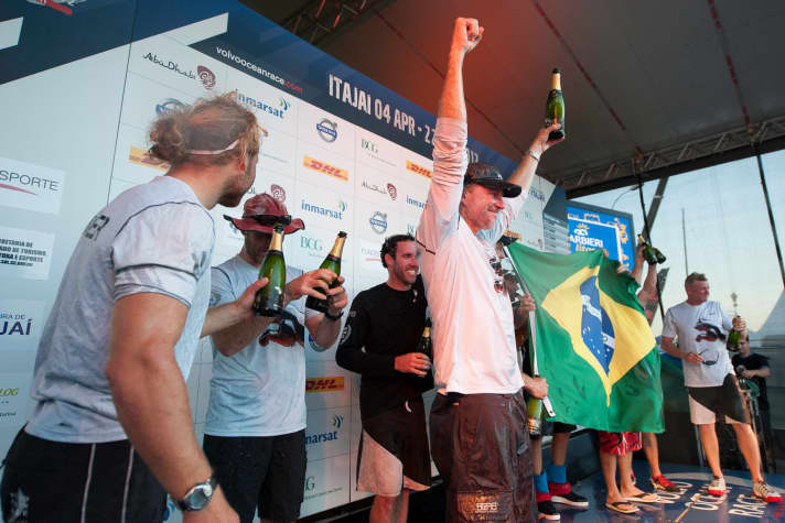   Cheers at Puma during the obligatory champagne shower at the finish: Michael Müller (left) and skipper Ken Read (centre)