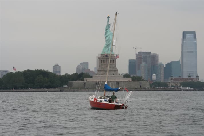   "Constellation" in front of the Statue of Liberty