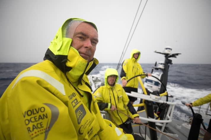   After one of the countless rain showers near the equator: Brunel skipper Bouwe Bekking and his watch on board the yellow boat