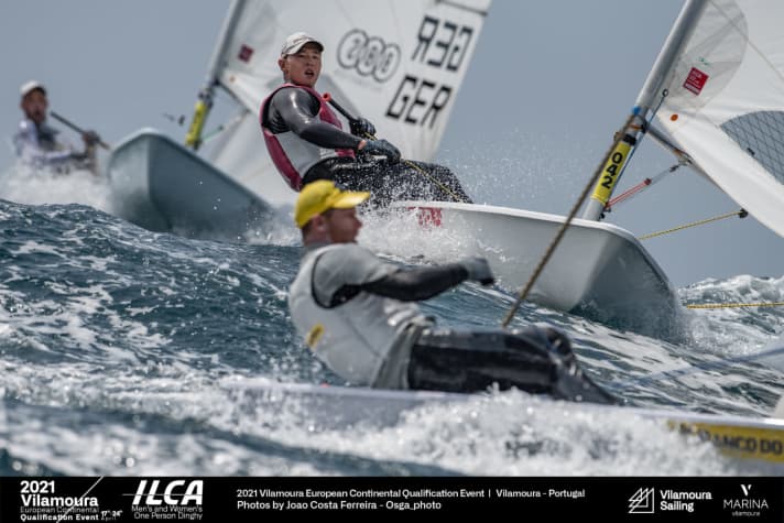   Spectacular study by event photographer João Costa-Ferreira: Robert Scheidt works in the laser at the front of the picture. Behind another competitor, Philipp Buhl powerfully approaches the...