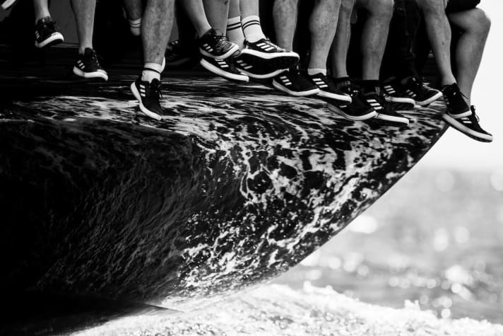   Legs dangle from the front row seats at the Palmavela 2022 ...