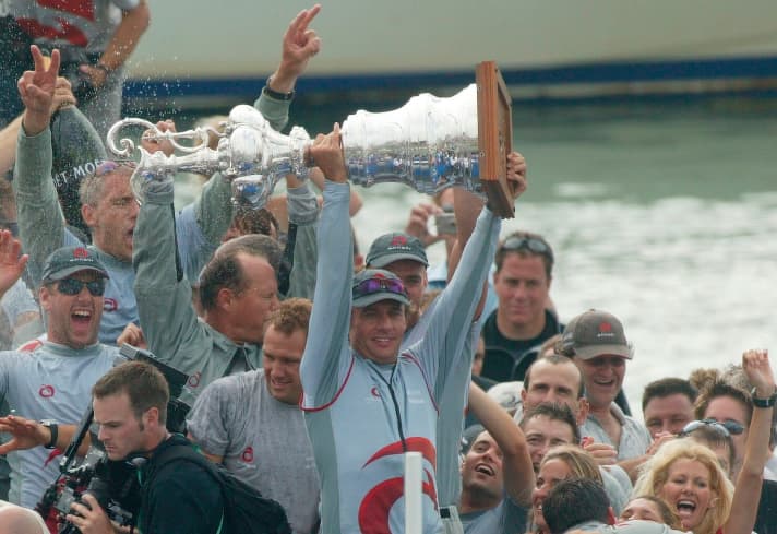   Ernesto Bertarelli lifts the America's Cup as a proud winner into the sky above Auckland. He won the Cup here for the first time in 2003