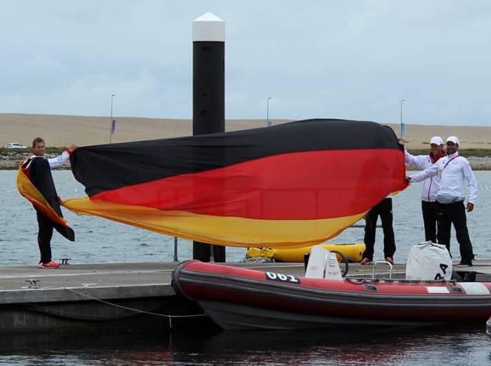   The coaches greet the surfers on their return to the Olympic harbour