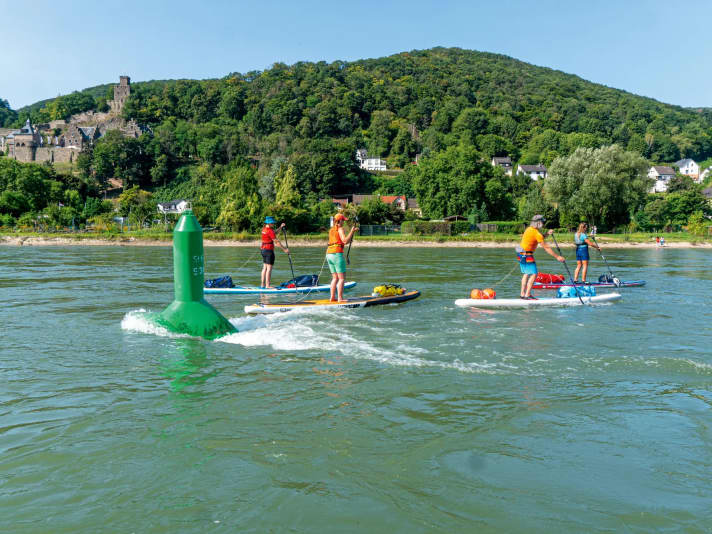 On federal waterways you should - if at all possible - paddle outside the navigation channel.  In other words, downstream to the left of the green buoys.