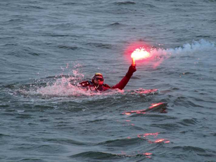 Shipwrecked person with hand signal torch Exercise of the German Maritime Search and Rescue Service (DGzRS)