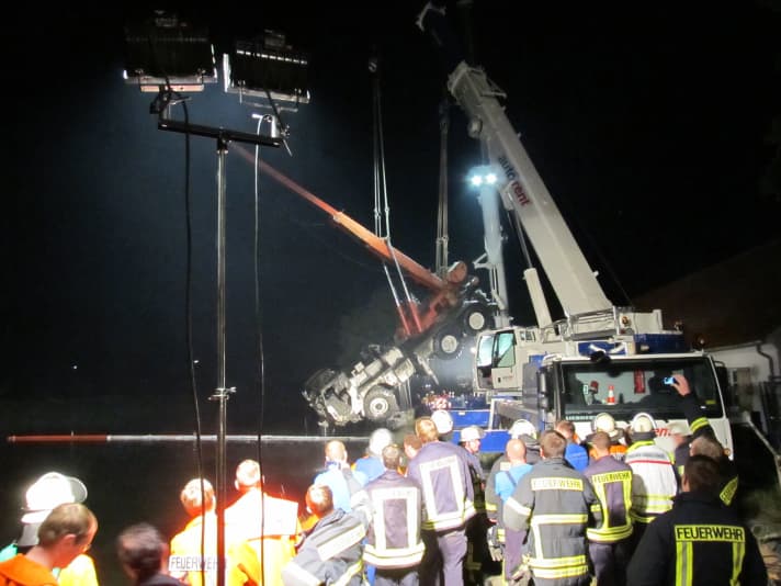   The salvaged casualty is suspended in two powerful fire brigade recovery cranes