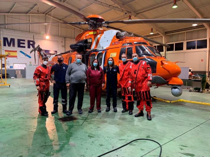   Crew (centre) and rescuers back on land