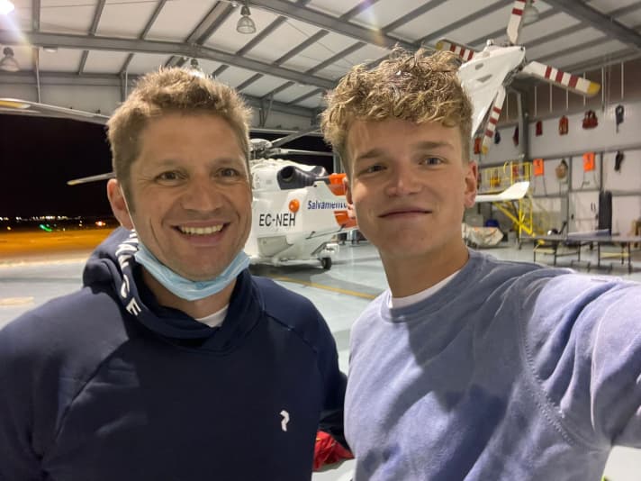   Melwin Fink and Marc Menzebach in front of the helicopter that flew them at 300 kilometres per hour from the scene of the accident to Mallorca