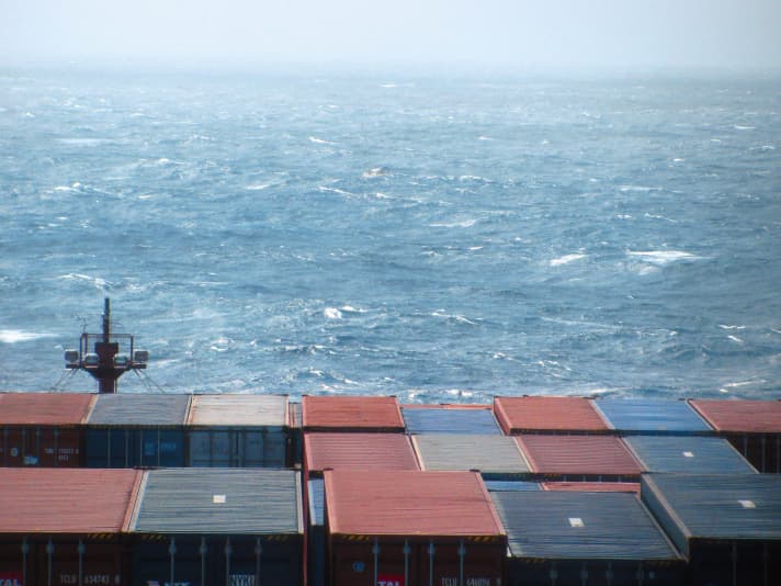   Tiny boat in a choppy sea - a search picture. Although a rescue plane is transmitting the position, it seems almost hopeless to discover the sailor in the middle of the waves (in the centre of the upper third of the picture)