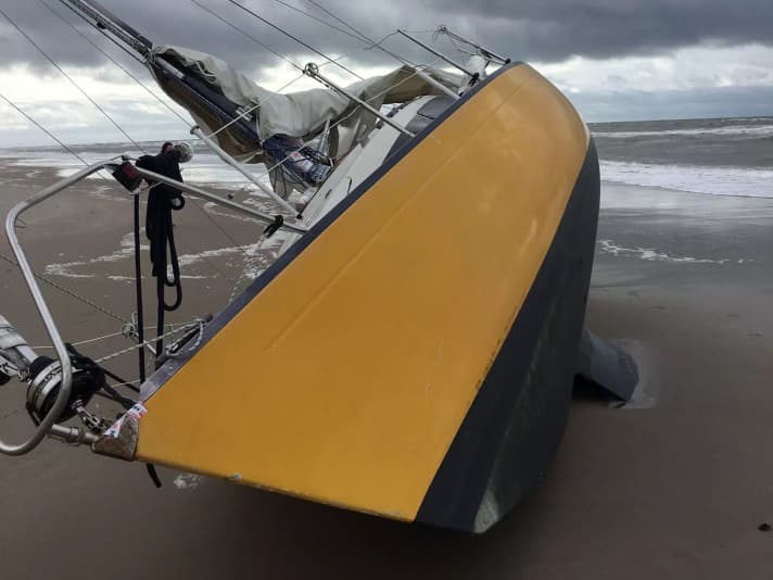 A stranded sailing yacht on the Danish coast.