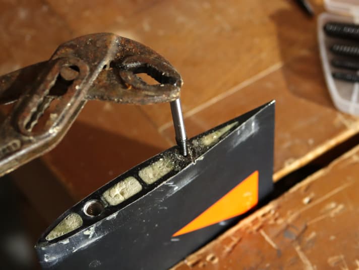 ...and then screw in the appropriate screw extractor. Note: This has a left-hand thread and gets thicker towards the top. If you continue to screw in the screw extractor with the pliers, the screw will start to unscrew at some point.