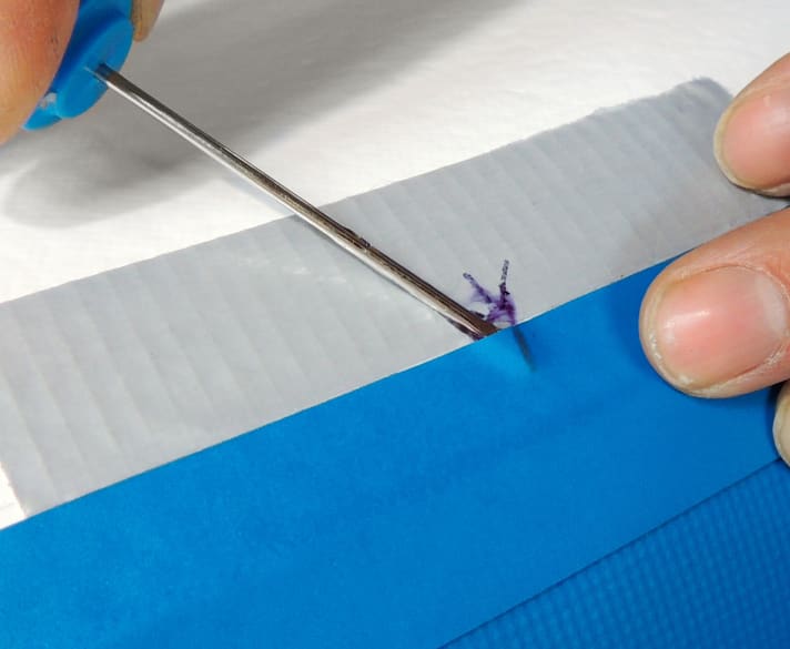 Use a small screwdriver to remove the tape very carefully without damaging the tape or board (3).