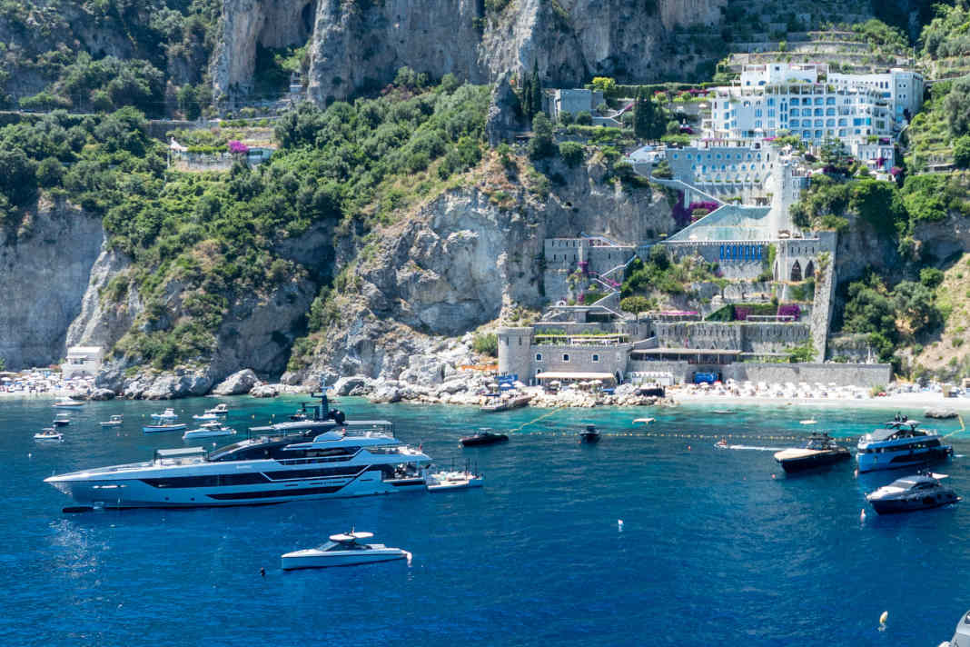 Riva 54METRI: The aluminium Riva is moored in the bay off the hotel beach.
