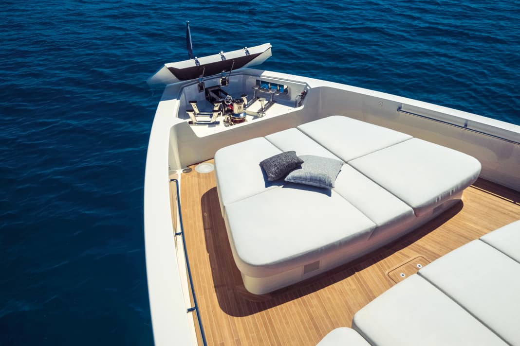 The sun lounger at the bow is surrounded by sea air, the cleats and anchor winch are concealed