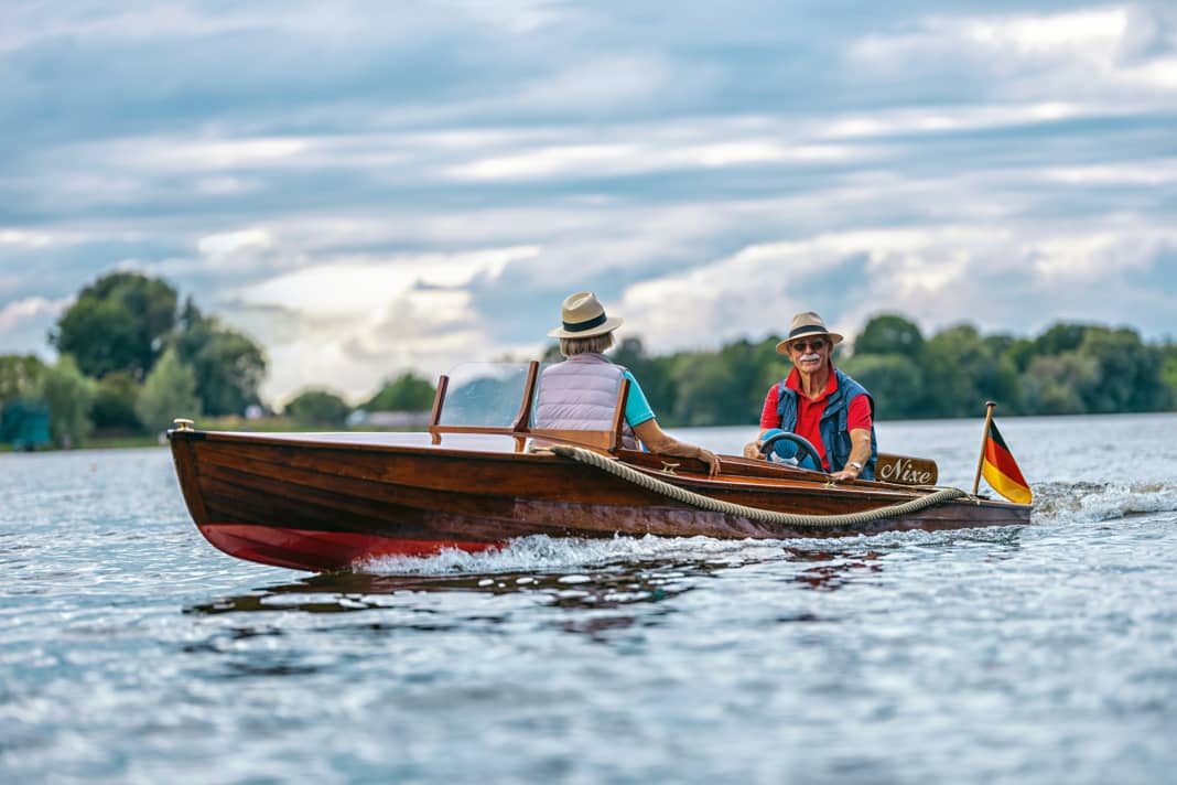 Owner Menno Wolters at the helm of his "Nixe" during a trip on the Dove-Elbe near Hamburg
