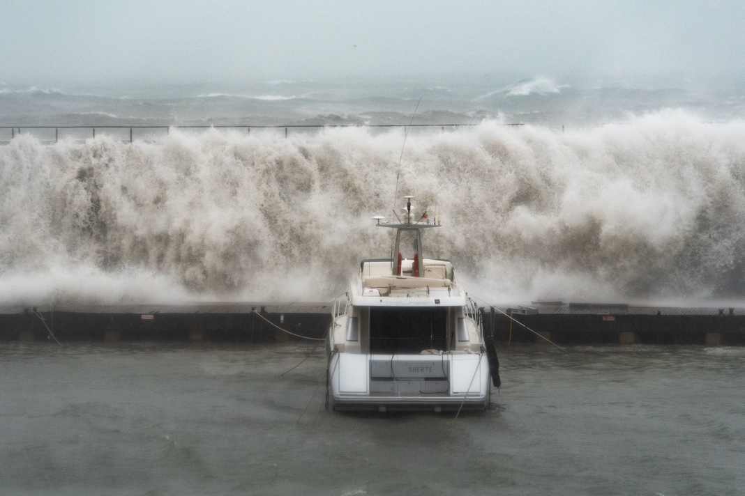 Wind-swept and bleak. Waves crash against the walls of the Port Olympic Marina in Barcelona.