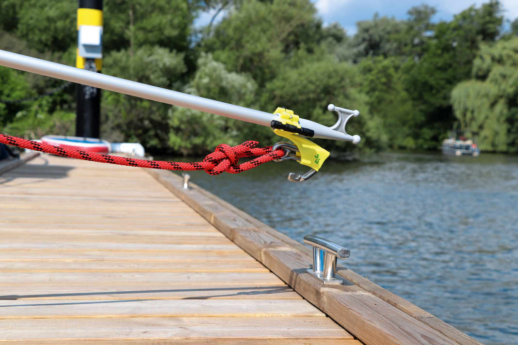 With the mooring line attached, the carabiner can be slid into the yellow holder and ...