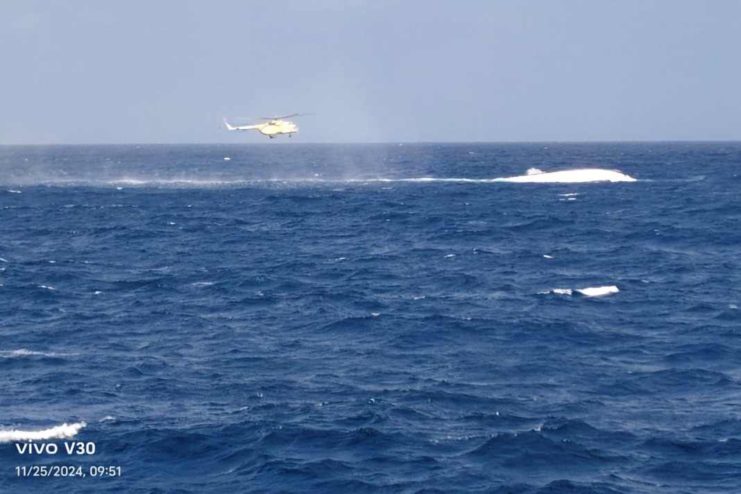 Ein Teil der gekenterten „Sea Story“ ragt aus dem Wasser, während ein Hubschrauber die Unglücksstelle überfliegt. Fünf Menschen harrten 34 Stunden in einer Luftblase im Wrack aus.