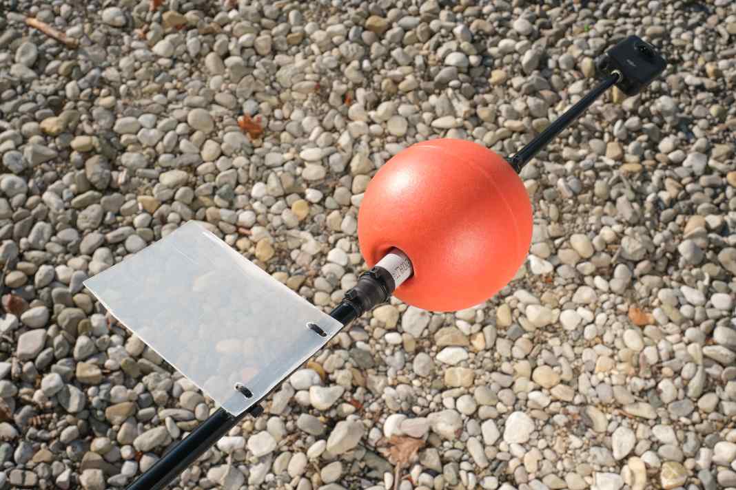 The rudder is a piece of plastic from an old transport box, held in place by two cable ties. The floating ball sits firmly on the tube.