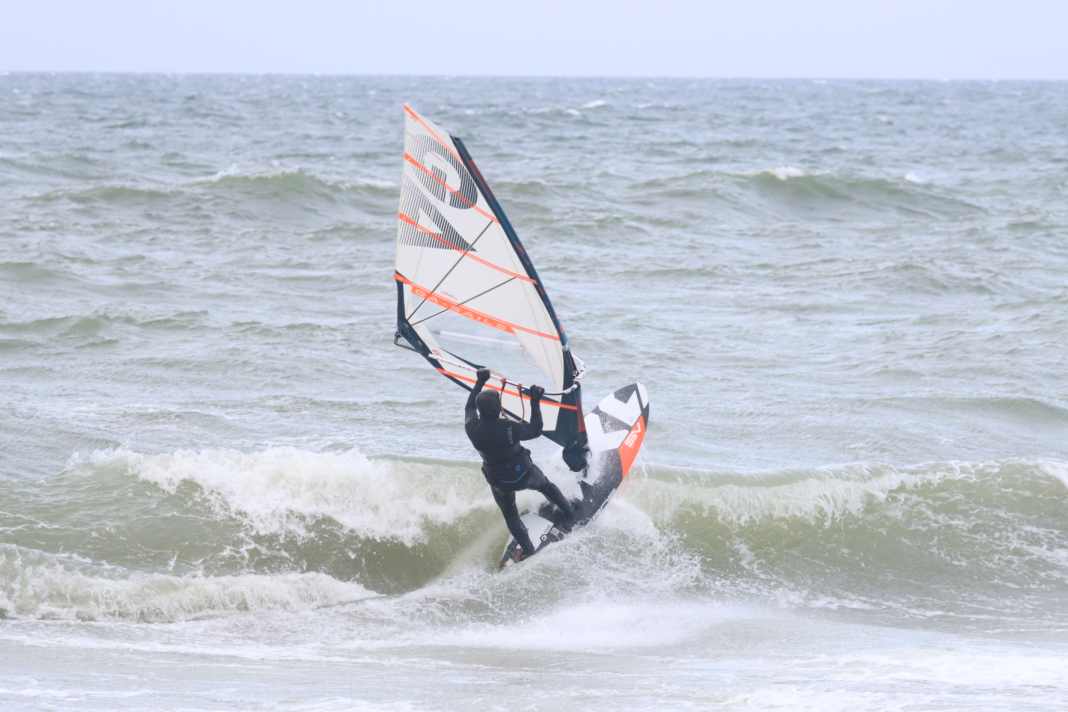 The High Five: The breaking wave’s crest strikes the underside of the board