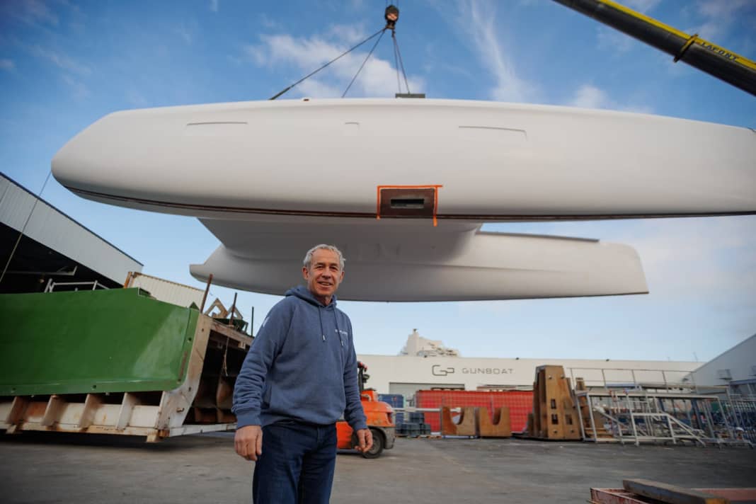 The hull of Jourdain's Outremer 5X hangs in the crane.
