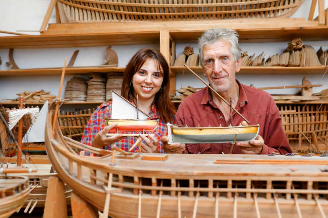 Daughter Rigina and father Yannis Boudalas with small models that they offer as souvenirs