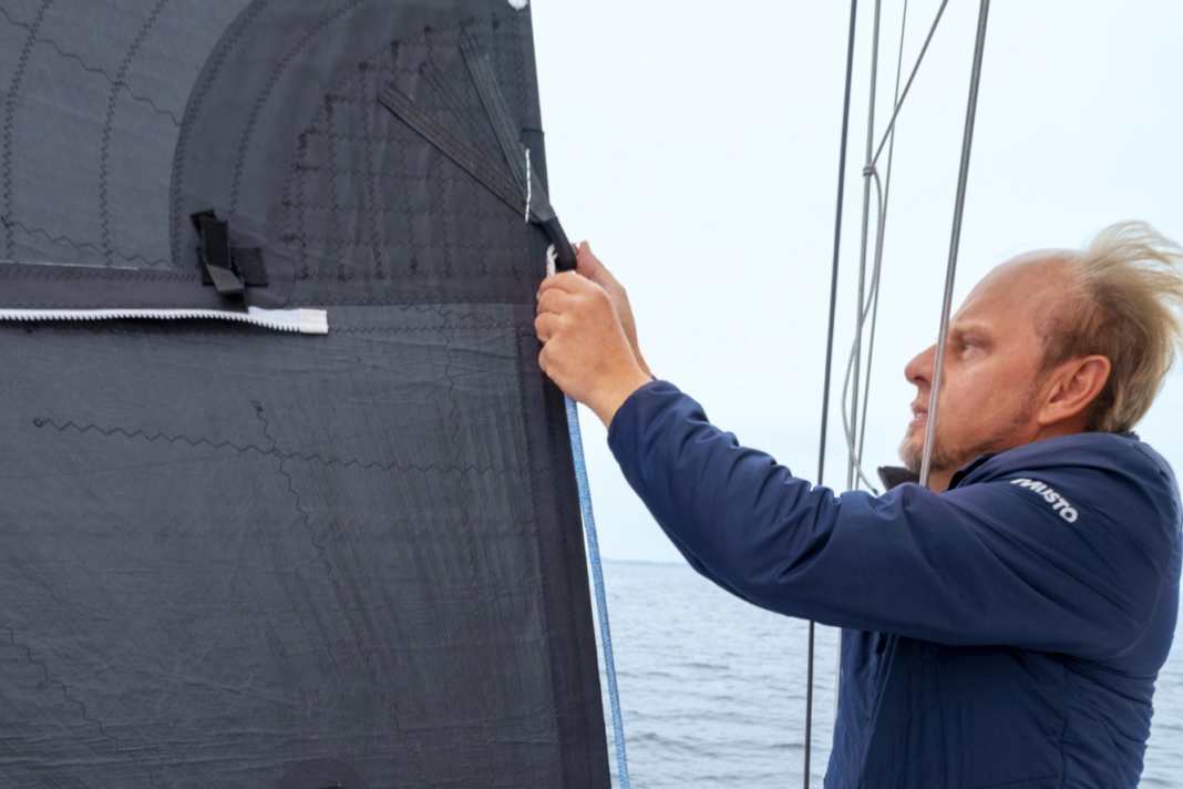 Reposition the sheet: Change the windward sheet to the upper clew and lead it through the lee haul point. Then drop it so far that the jib is covered