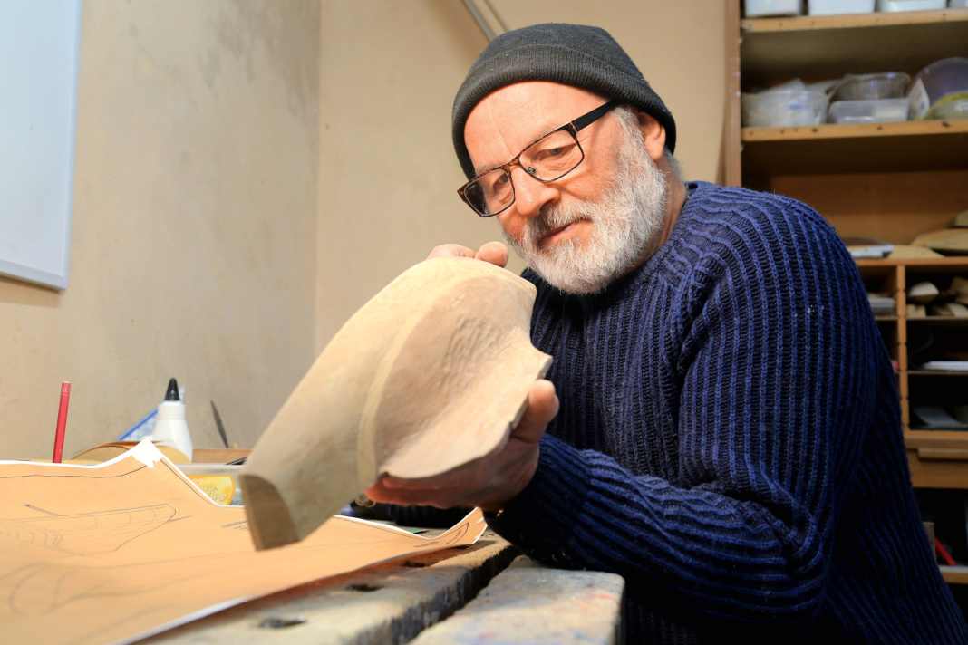 Old school: With a practised eye, Jürgen Oltmann checks a half-model on the Strak.