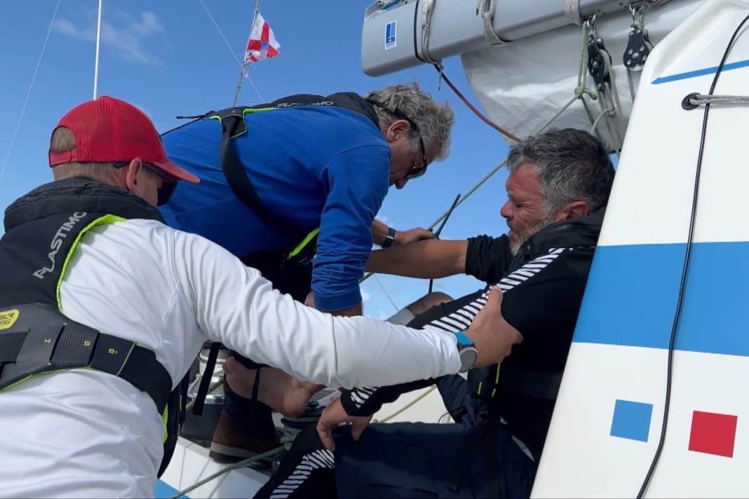 The injured crew member is brought on deck ...